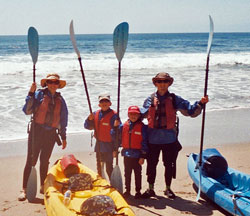kayaking family on beach