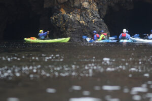 Kayak guide Aubrie Fowler leads a sea cave kayak tour at Scorpion Anchorage